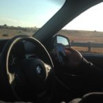 What is the fine for driving with a phone in your hand?